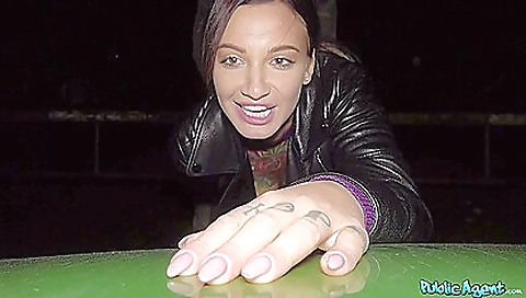 Hot brunette and tattooed babe in a sexy outfit ride car