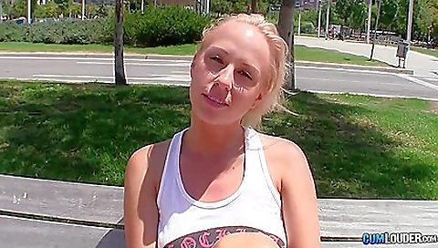 Blonde teen with a big cock is getting a handjob outdoors